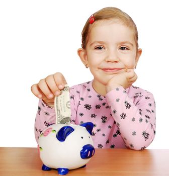Little girl with piggy bank studio shot