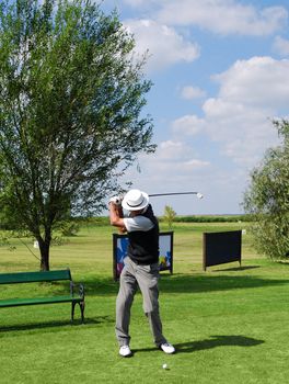 Senior golf player hit ball