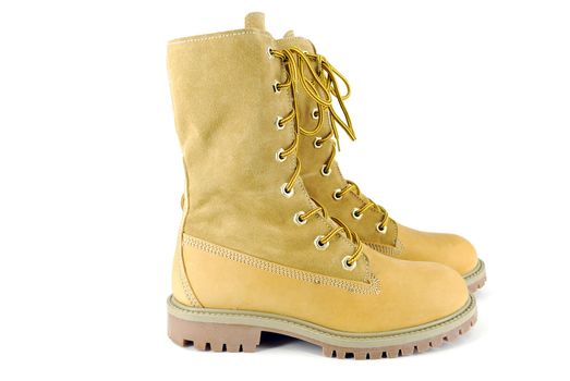 Yellow tall hiking boots on white