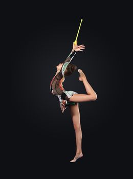 Young cute woman in gymnast suit show athletic skill on black background