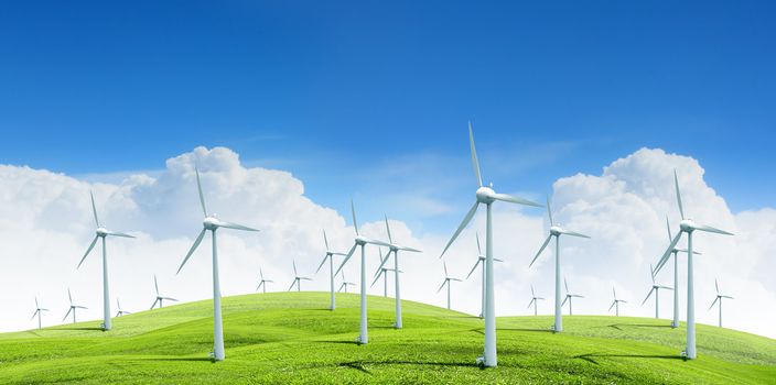 Alternative energy.  Group of energy-producing windmills agains blue sky