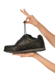 New model of black urban footwear in saleswoman's hands