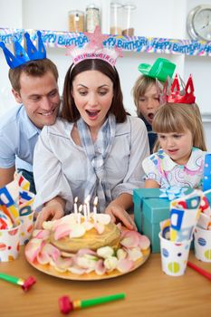 Attractive mother celebrating her birthday in the kitchen