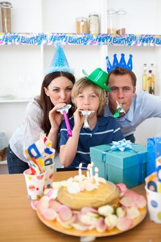 Joyful parents celebrating their son's birthday in the kitchen