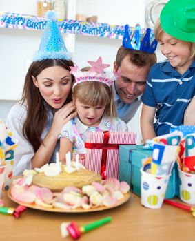 Cheerful little girl celebrating her birthday in the kitchen