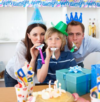 Jolly parents celebrating their son's birthday in the kitchen