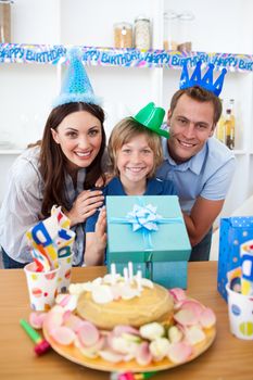 Lively parents celebrating their son's birthday in the kitchen