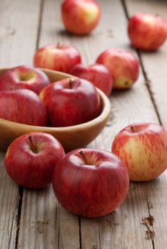 A bowl of red apples on the wooden table