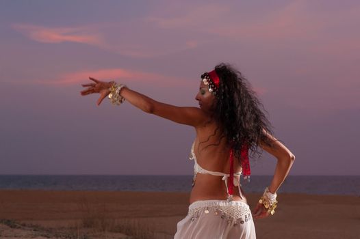 Oriental dance on an evening beach setting