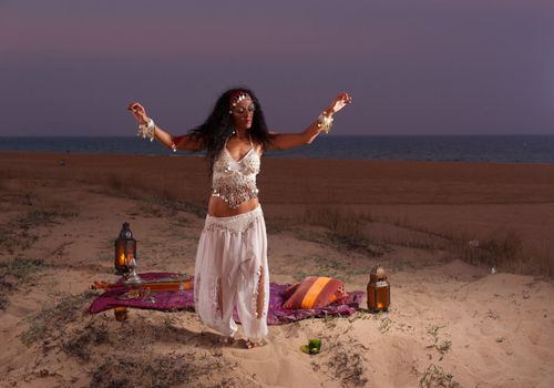 Oriental dance on top of a scenic coastal dune