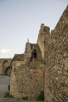 Carol model on a stone stair in the castle of Ainsa in Spain