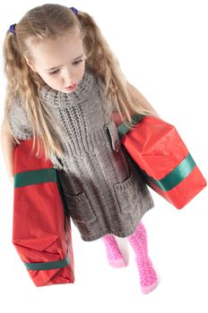 Beautiful girl walking with christmas presents on white