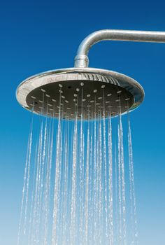 Outdoors shower pouring water against blue sky