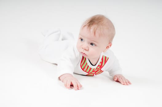 Baby boy in white costume on light background