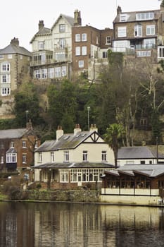 Town of Knaresborough, England, with its quiant historical houses reflected in the water of the river below