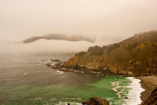Fog banks layer the coastal bays of California coast USA