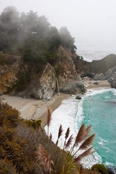 Waterfall in beautiful sheltered cove California coast