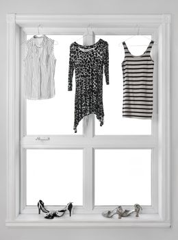 Black and white clothes hanging in the window.