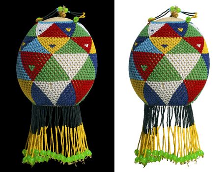 Ostrich egg decorated with multicolored beads on black and white background