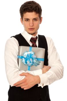 handsome man holding in the hands the gray box with blue ribbon as a gift for his girlfriend