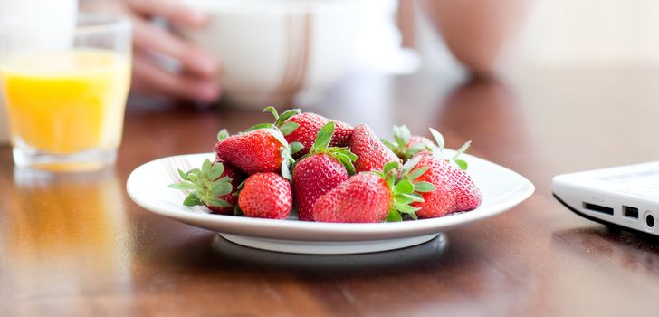 Close-up of a plate of strawberries on a table