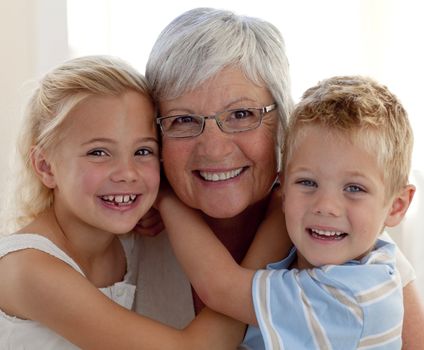 Portrait of smiling grandmother and grandchildren hugging