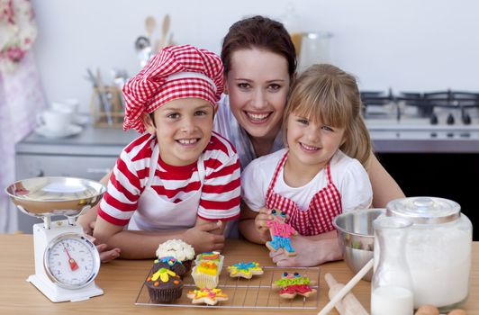 Happy woman and children baking in the kitchen