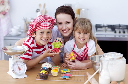 Happy mother baking with children in the kitchen