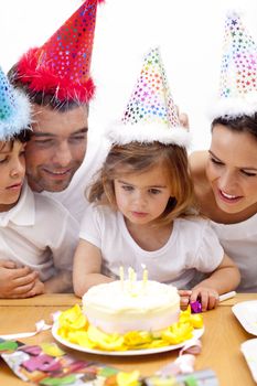 Little girl celebrating her birthday with her parents at home