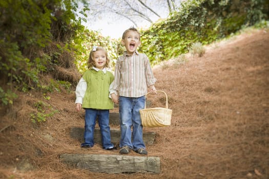 Adorable Brother and Sister Children Holding Hands Walking Down Wood Steps with Basket Outside.