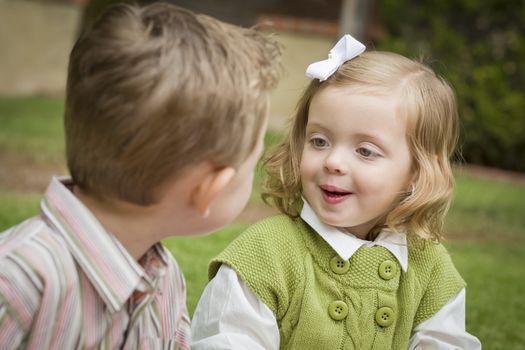 Adorable Brother and Sister Children Playing with Each Other Outside.