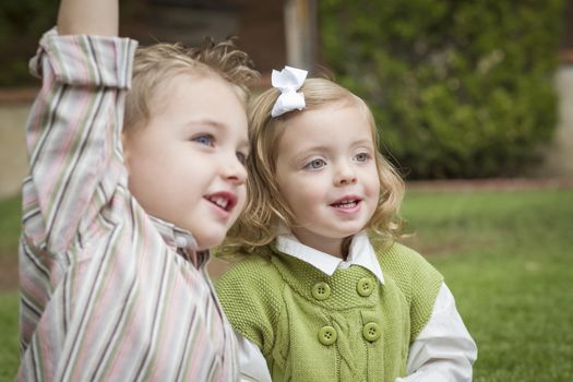 Adorable Brother and Sister Children Playing with Each Other Outside.