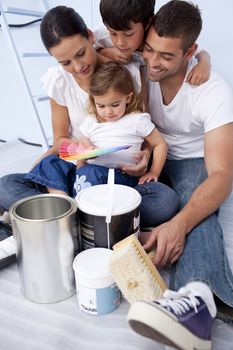 Happy family chosing colours to paint a bedroom