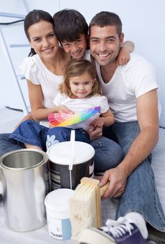Happy family chosing colours to paint new house