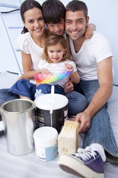 Happy family with colour samples to paint new house