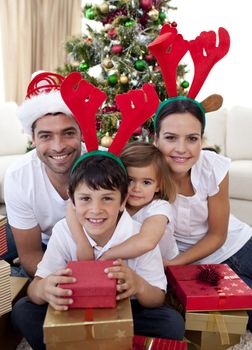 Lovely family giving presents for Christmas