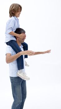 Man giving son piggy back ride with eyes closed against white background