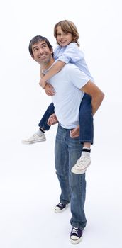 Dad giving son piggy back ride against white background