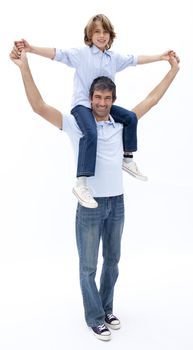 Father giving son piggy back ride against white background