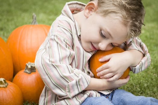 Adorable Young Child Boy Enjoying the Pumpkins at the Pumpkin Patch.