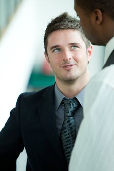 Smiling business men talking in an office