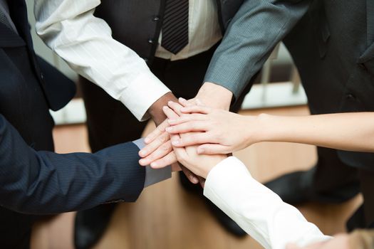 High view of people with hands together. Concept of union in business