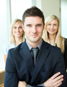 Portrait of three young business people with folded arms
