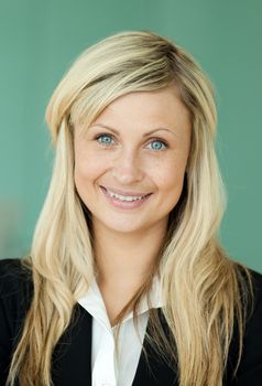 Blond business woman with a green background