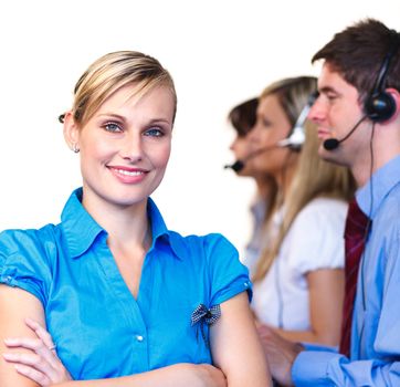 Young businesswoman in front of her team in a call center