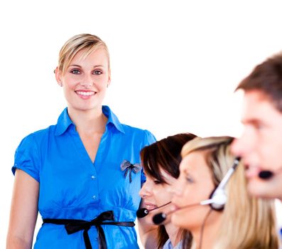 Young businesswoman with her team in a call center 