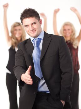 Businessman offering a handshake at camera