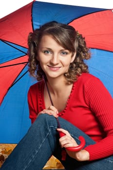 Portrait of a young woman holding an umbrella posing on white