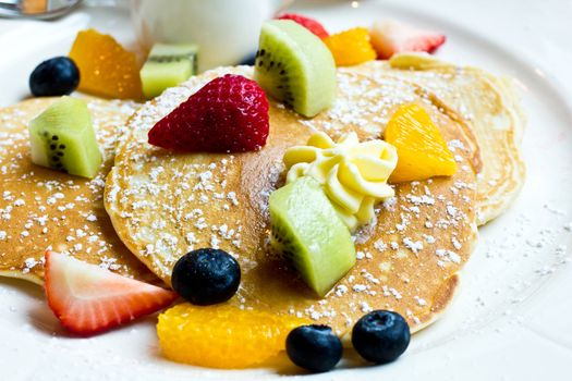 Delicious pancake with fresh stawberry, kiwi, orange, blueberry.