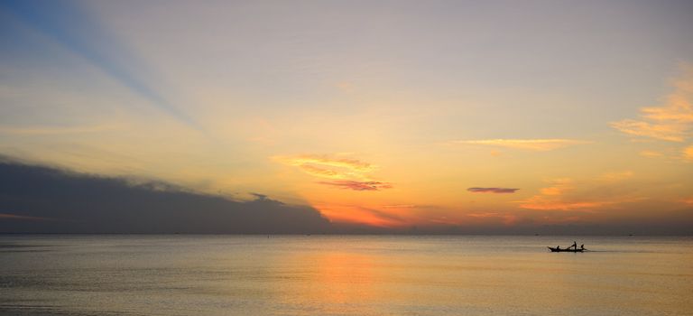 Fisherman are taking fishing boat to fish with sunrise background.